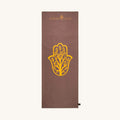 Brown yoga towel with yellow Hamsa hand design and 'Karma Luck' branding on a white background